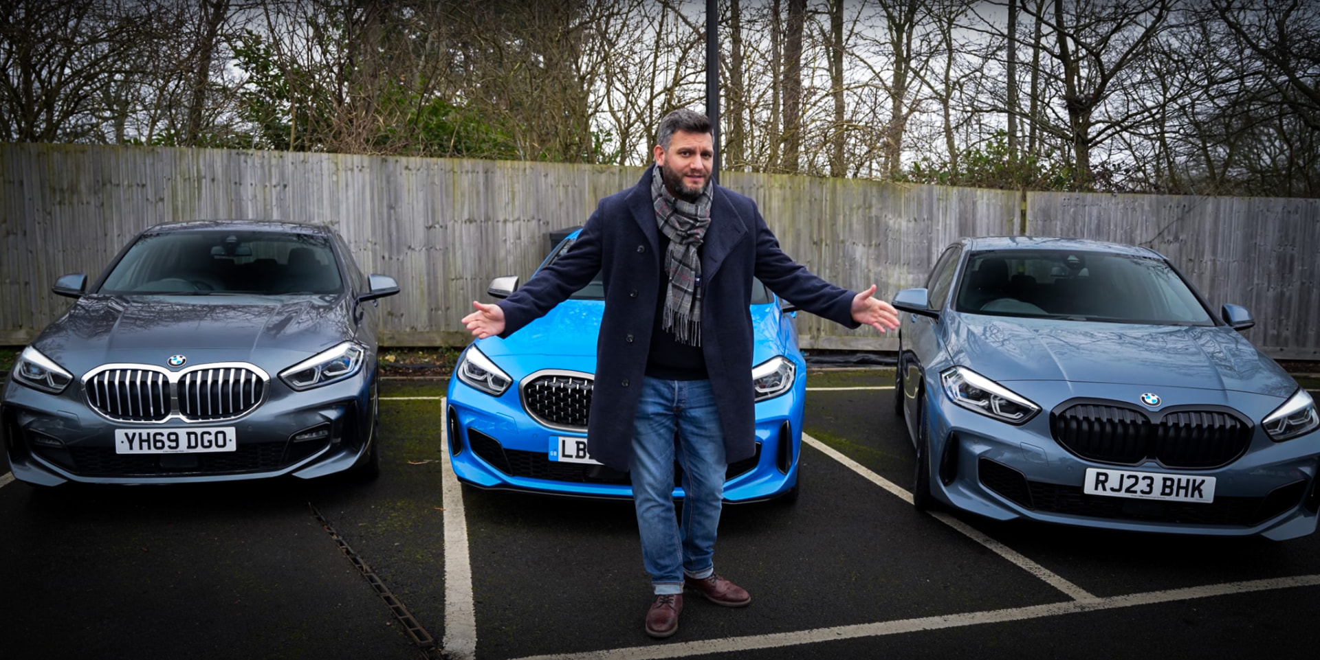 Presenter delivering video content in front of three BMW 1 Series cars